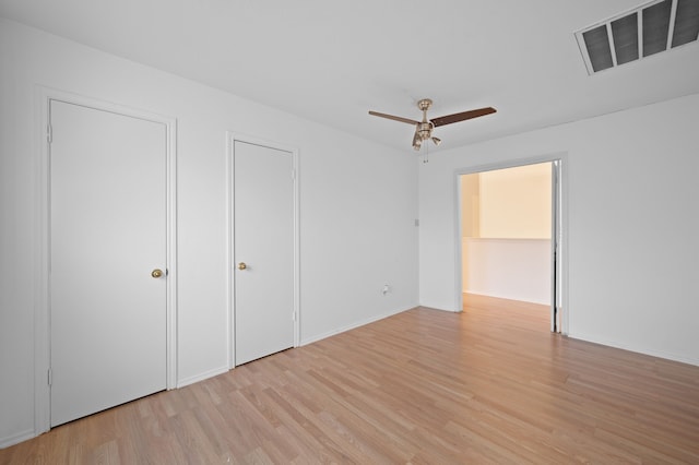 unfurnished bedroom with ceiling fan and light hardwood / wood-style flooring