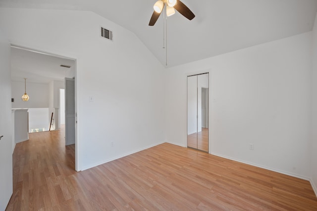 unfurnished room featuring ceiling fan, lofted ceiling, and light wood-type flooring