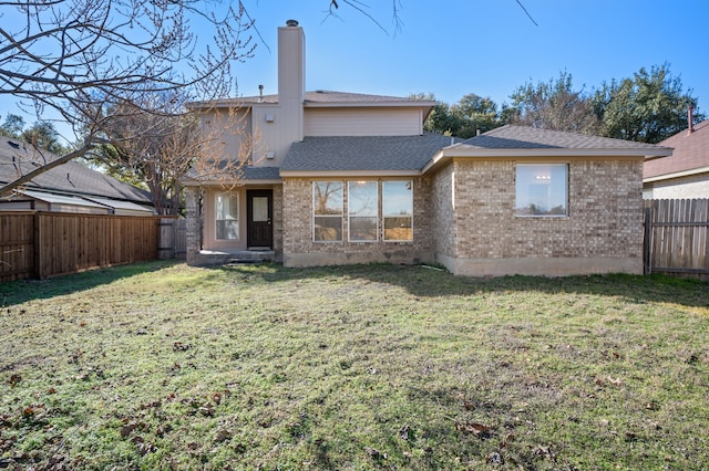 rear view of house with a yard