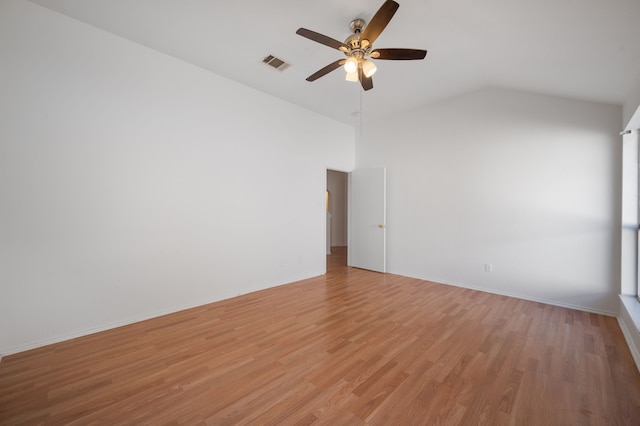 unfurnished room featuring lofted ceiling, light wood-type flooring, and ceiling fan