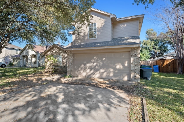 view of front facade with a garage and a front lawn