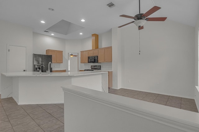 kitchen with light tile patterned flooring, high vaulted ceiling, a large island, and black appliances