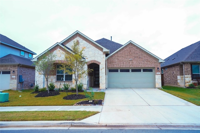 view of front of property featuring a front yard and a garage