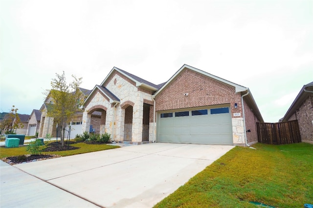 view of front of property with a front yard and a garage