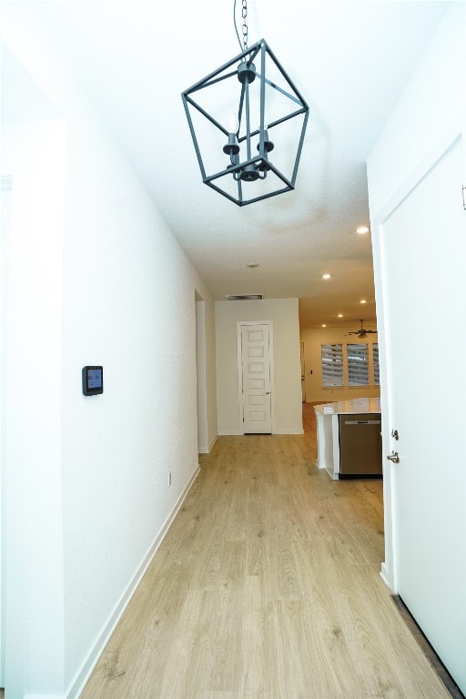 interior space with light hardwood / wood-style floors and a chandelier