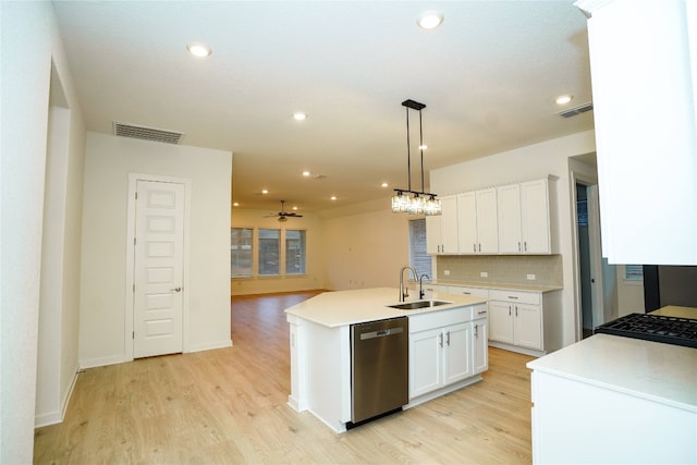 kitchen featuring a kitchen island with sink, white cabinetry, sink, and stainless steel dishwasher