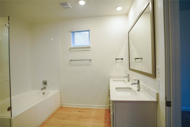 bathroom with vanity, separate shower and tub, and wood-type flooring