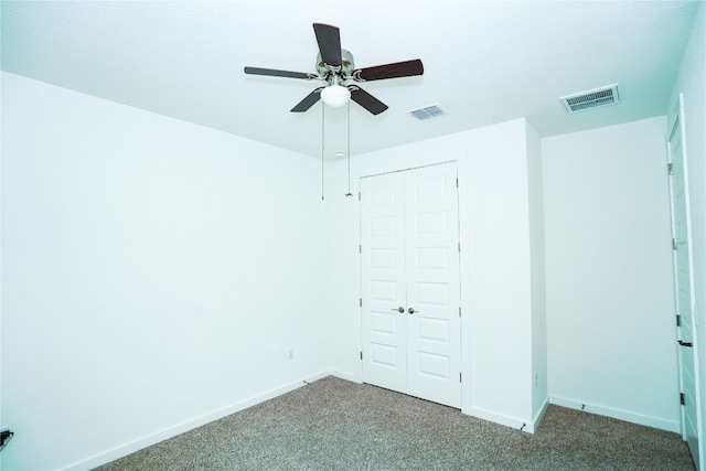 unfurnished bedroom with ceiling fan, a closet, and carpet floors