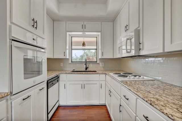 kitchen featuring white cabinets, white appliances, and sink