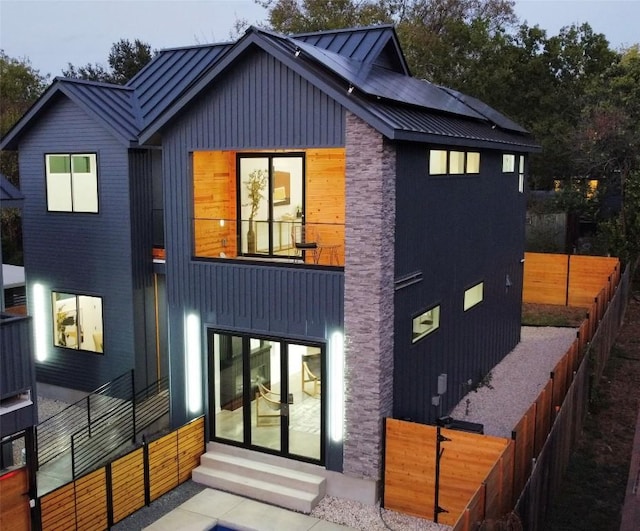 rear view of property featuring a balcony