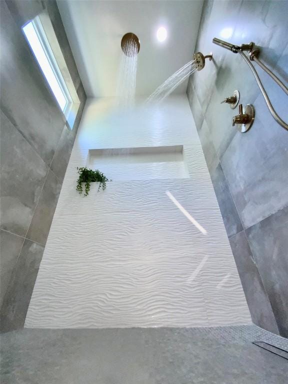 interior details featuring a tile shower