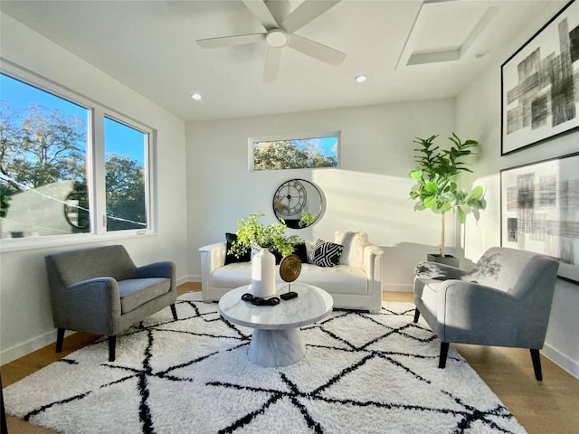 living area with ceiling fan and light hardwood / wood-style floors