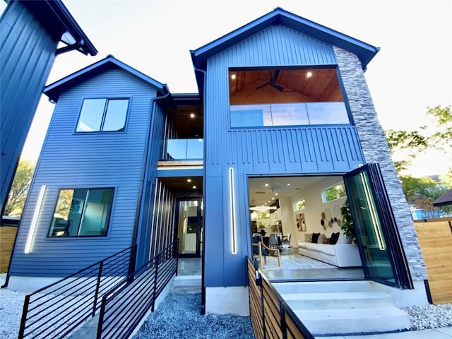 back of house featuring a balcony and ceiling fan