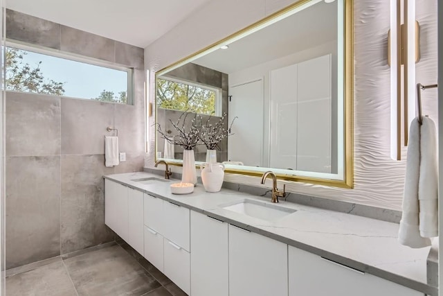 bathroom with vanity and tile walls