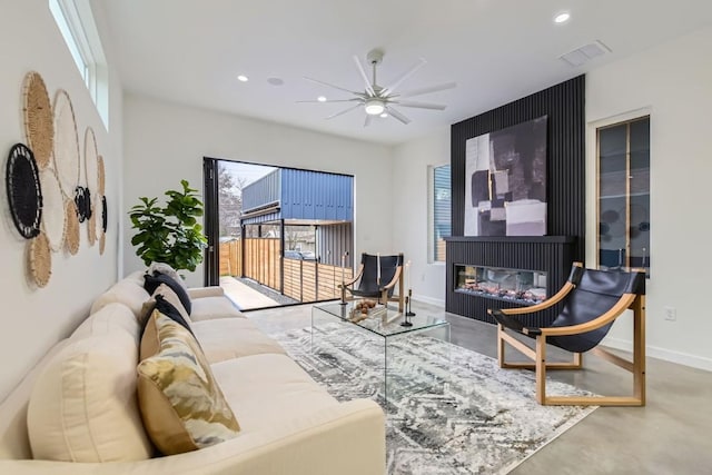 living room featuring ceiling fan and concrete floors