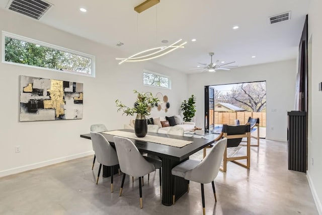 dining space with concrete floors and an inviting chandelier