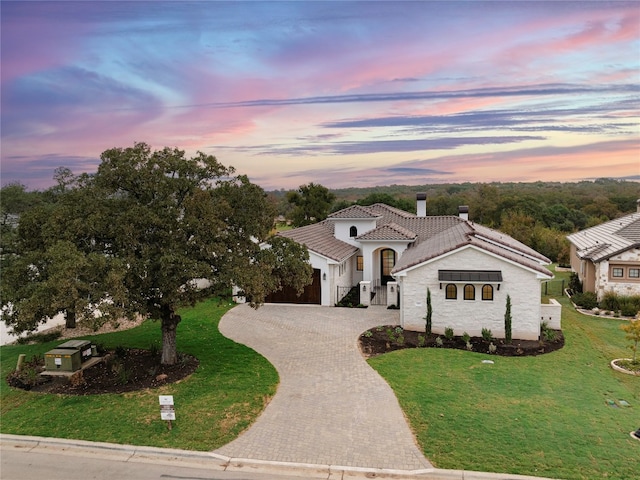 mediterranean / spanish home with a yard