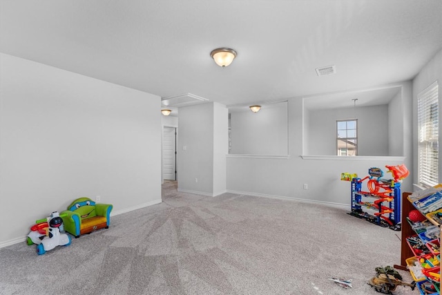 rec room with light colored carpet