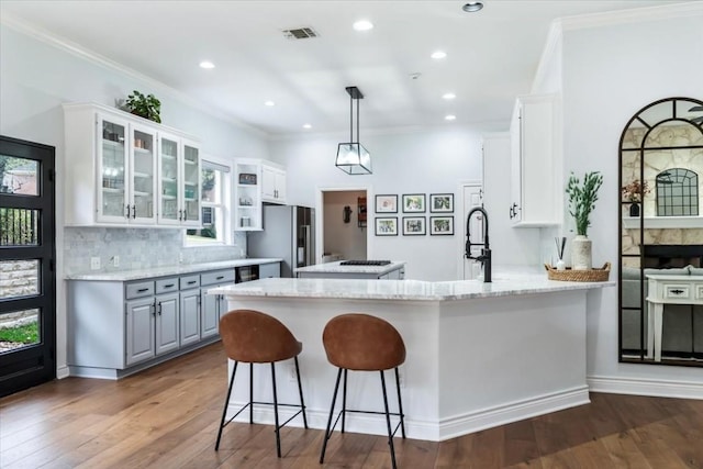 kitchen with gray cabinetry, white cabinets, stainless steel refrigerator with ice dispenser, dark hardwood / wood-style flooring, and kitchen peninsula