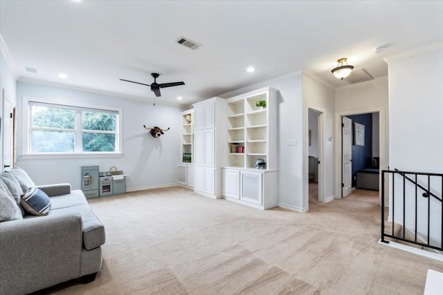 living room with ceiling fan, light colored carpet, and ornamental molding