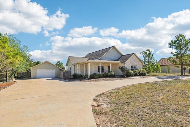 view of front of property with a garage and an outdoor structure