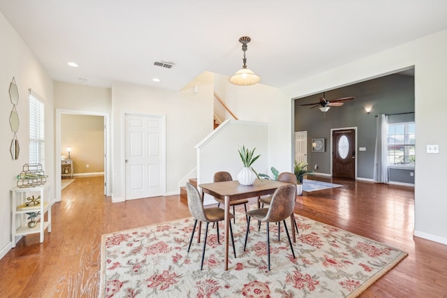 dining area with hardwood / wood-style flooring and ceiling fan