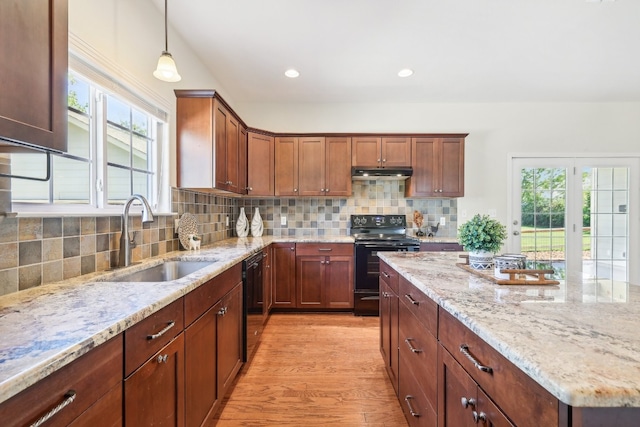 kitchen featuring sink, black appliances, plenty of natural light, and light hardwood / wood-style floors