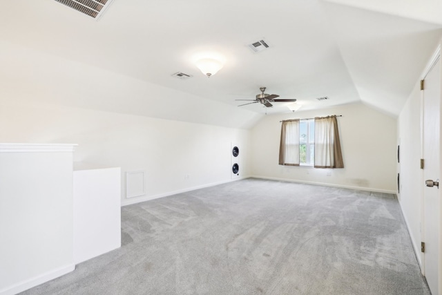 additional living space featuring light carpet, vaulted ceiling, and ceiling fan