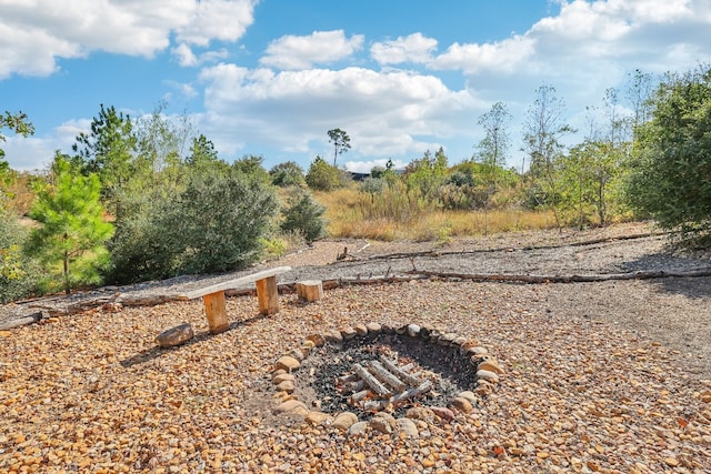 view of yard with a fire pit