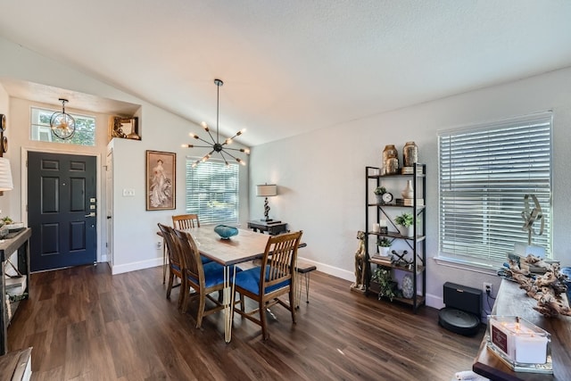 dining space featuring dark hardwood / wood-style flooring, vaulted ceiling, and an inviting chandelier