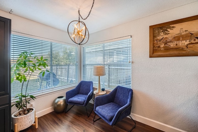 sitting room featuring a notable chandelier and dark hardwood / wood-style floors