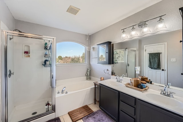 bathroom with vanity and independent shower and bath