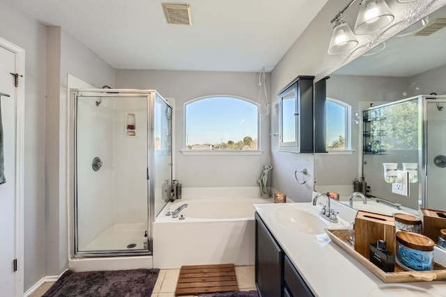 bathroom featuring separate shower and tub, tile patterned floors, and vanity