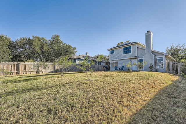 back of house featuring a yard