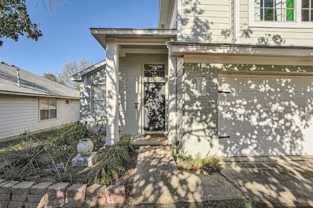 view of exterior entry with a garage