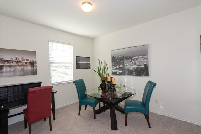 dining room featuring light colored carpet