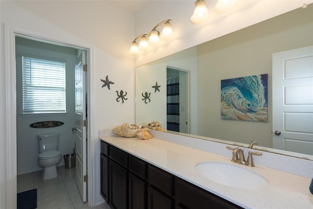 bathroom featuring tile patterned flooring, vanity, and toilet