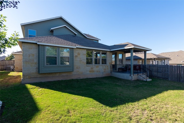 back of house featuring a lawn