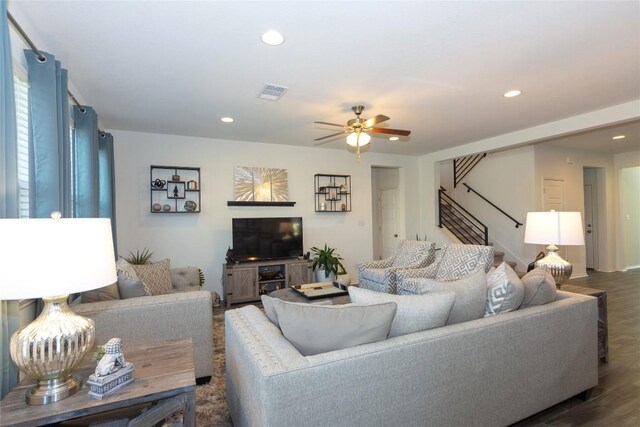 living room with dark hardwood / wood-style floors and ceiling fan