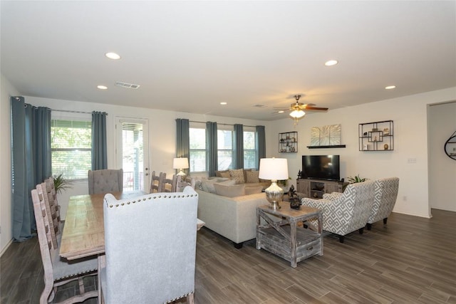 living room featuring ceiling fan and dark hardwood / wood-style flooring