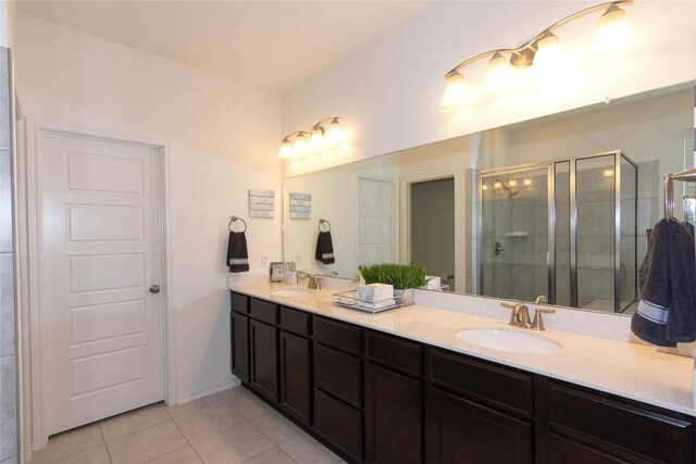 bathroom with tile patterned floors, vanity, and walk in shower