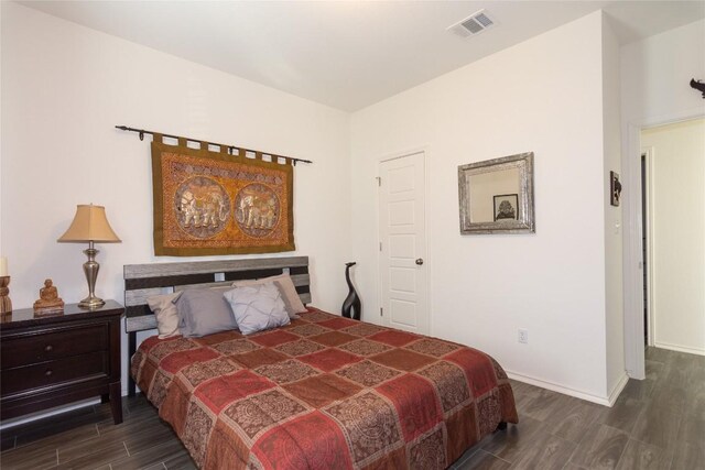 bedroom with dark hardwood / wood-style floors