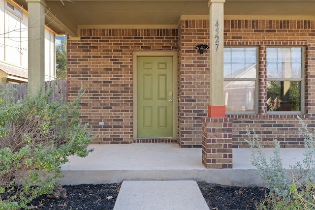 view of exterior entry featuring a porch