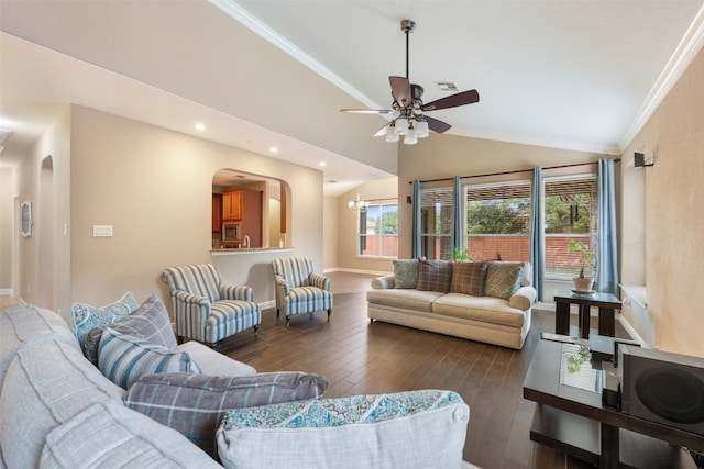 living room with dark hardwood / wood-style floors, lofted ceiling, crown molding, and ceiling fan with notable chandelier