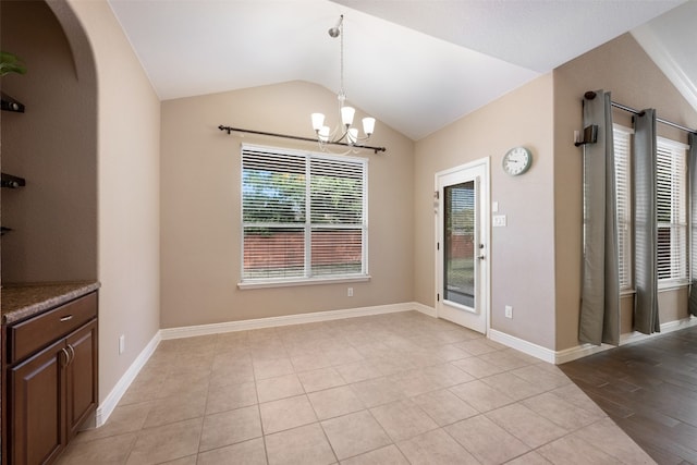 unfurnished dining area with light tile patterned floors, lofted ceiling, and an inviting chandelier