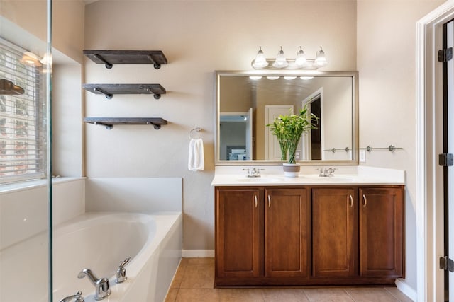 bathroom with tile patterned floors, vanity, and a tub