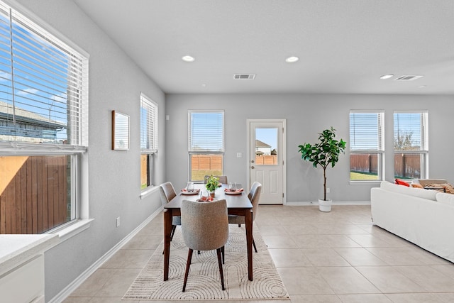 dining area featuring light tile patterned flooring