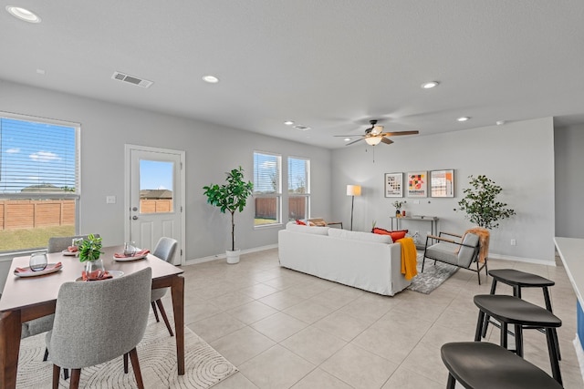 tiled living room with ceiling fan