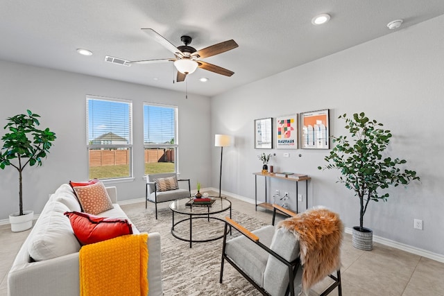 tiled living room featuring ceiling fan