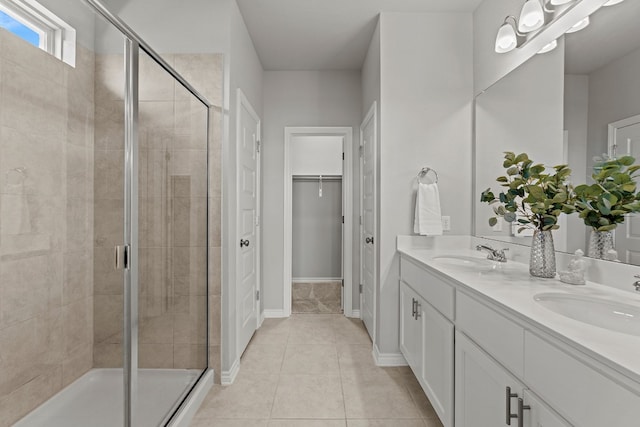 bathroom featuring tile patterned flooring, vanity, and an enclosed shower